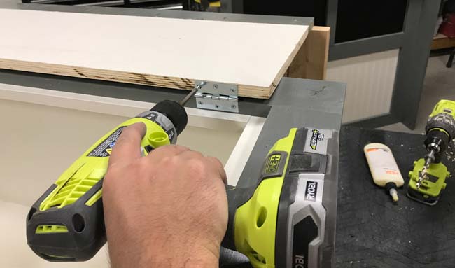 Attaching hinges to lid of hutch