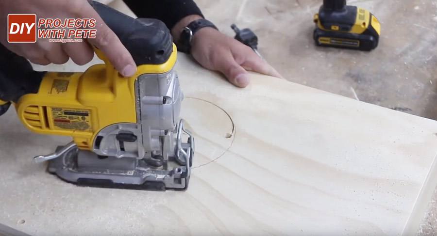 using a jig saw to make a hole in cornhole boards