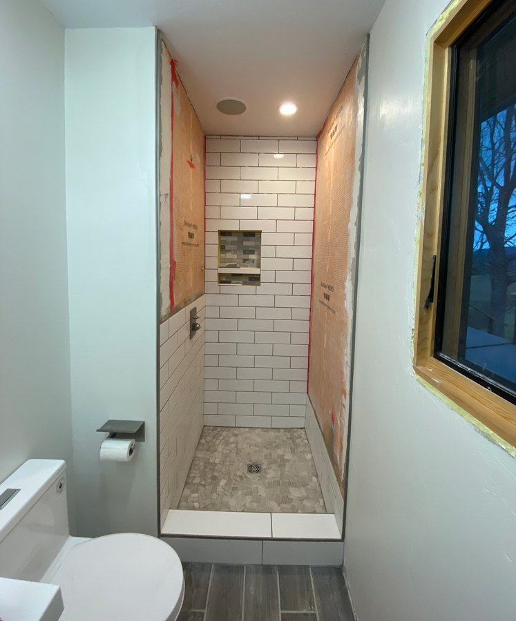 white subway tile in shower 
