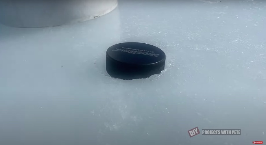 Hockey puck melted into the ice